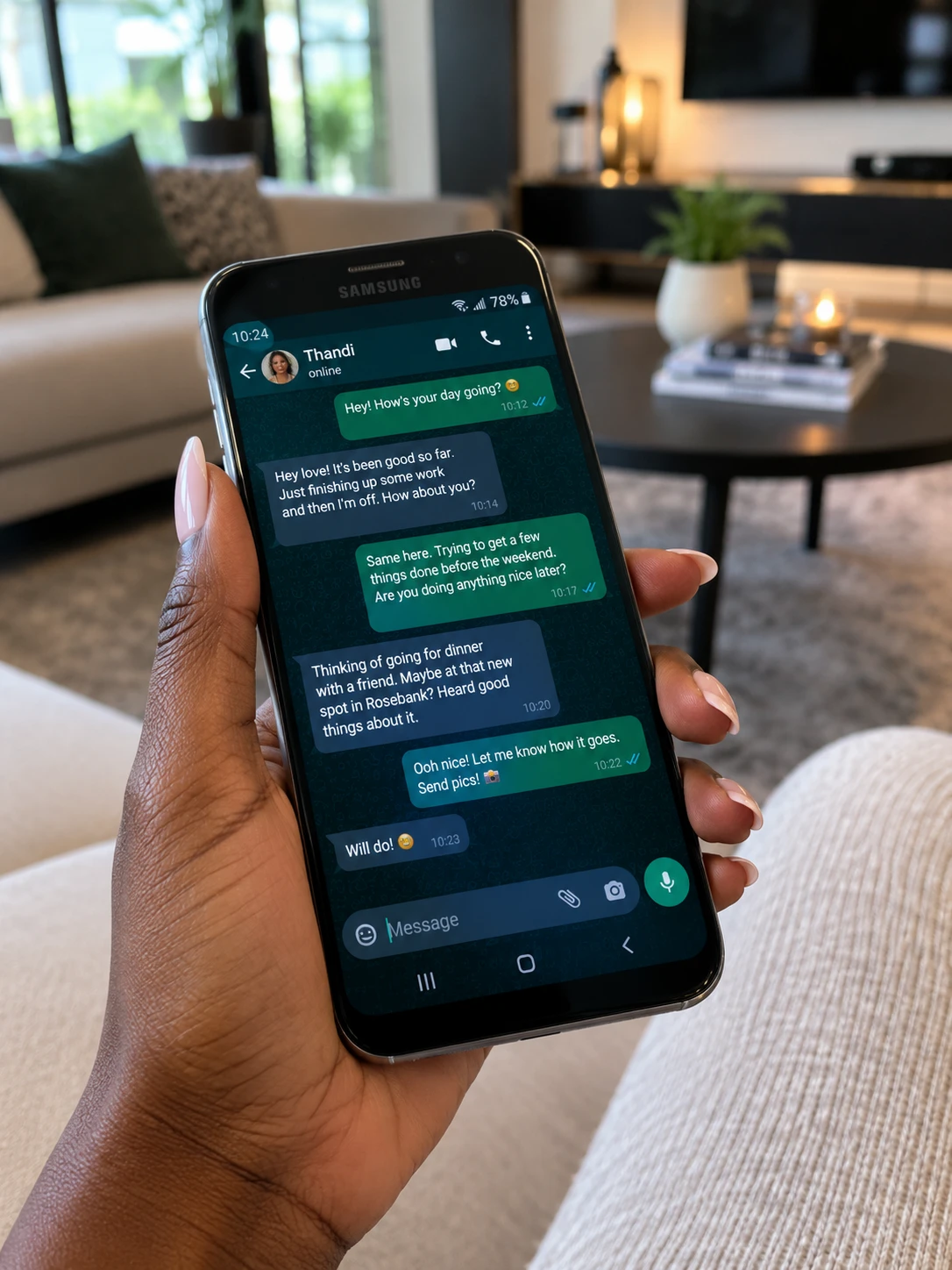 A woman holding a Samsung phone, chatting on WhatsApp